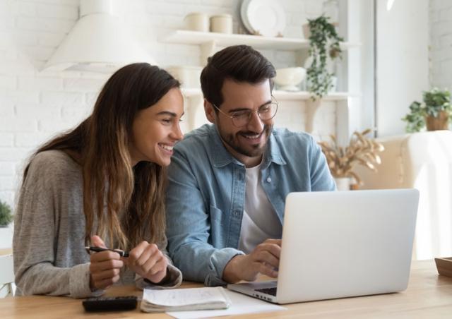 happy couple looking at computer